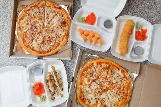 top view of pizza and sushi. Delivery in containers and boxes.