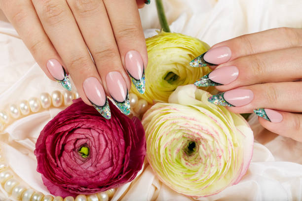 istock Hands with long artificial french manicured nails decorated with glitter 917194616
