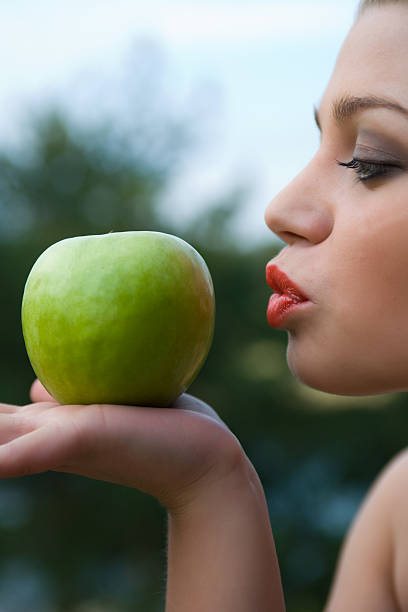 istock Girl with apple on sunset 91719542