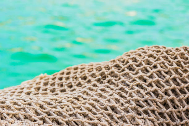 Close-up of fisher net pile at harbor with sea water background