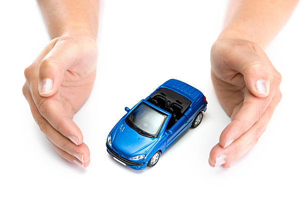 istock woman hands holding blue car isolated on white background 91719642