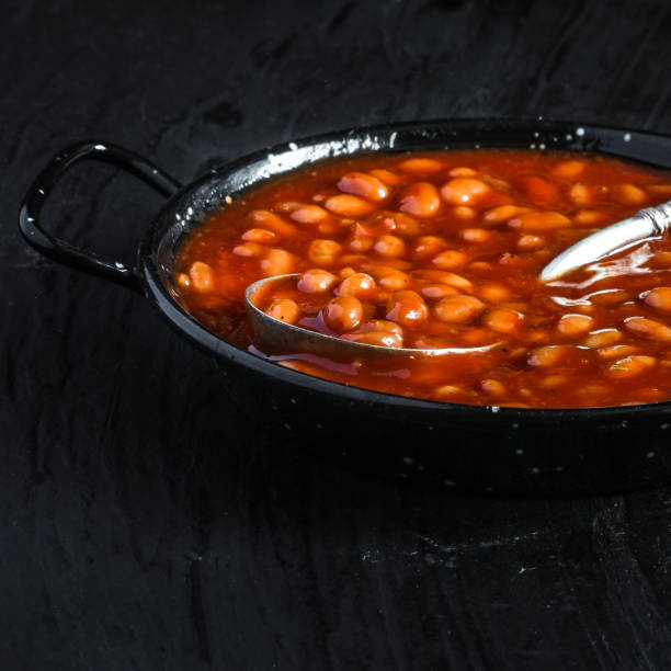 istock Beans in tomato sauce in a frying pan on a dark background 917196496