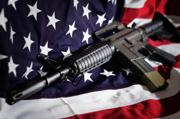 Photo of Flag of the USA with rifle