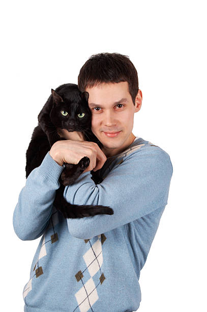 Young man with black cat stock photo