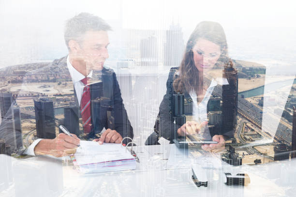 istock Two Businesspeople Calculating Tax In Office 917203024