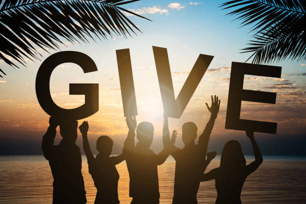 istock Business People Holding Give Text By Sea Against Sky 917203096