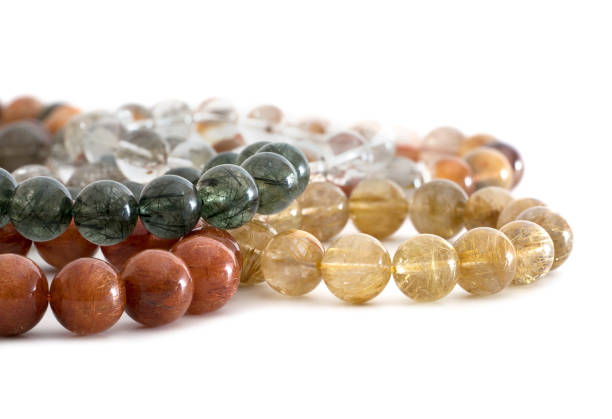 Beautiful translucent assorted colors Rutilated Quartz or Venus' hairstone bead in bracelets on white background