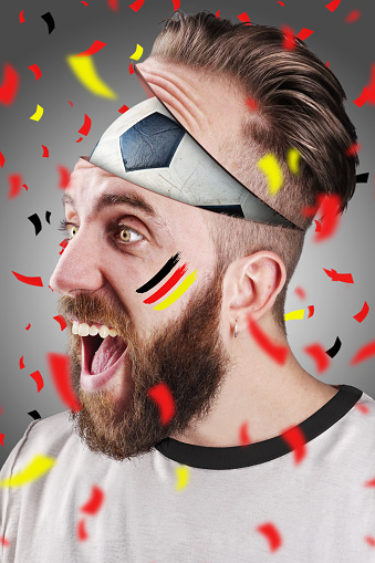 German soccer fan with football inside the head