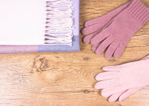 istock Warm winter knitted clothes on a wooden background. 917210728