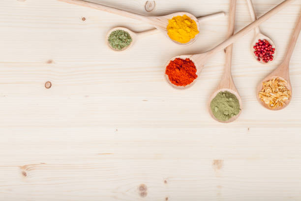 istock spices and herbs on kitchen wooden table background with copy space for text. food, cooking and restaurant concept. flat lay colorful composition, top view 917211366