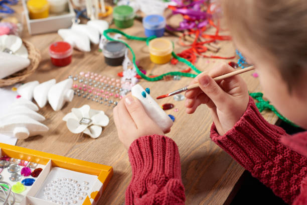 istock Child make crafts and toys, handmade concept. Artwork workplace with creative accessories. 917214080
