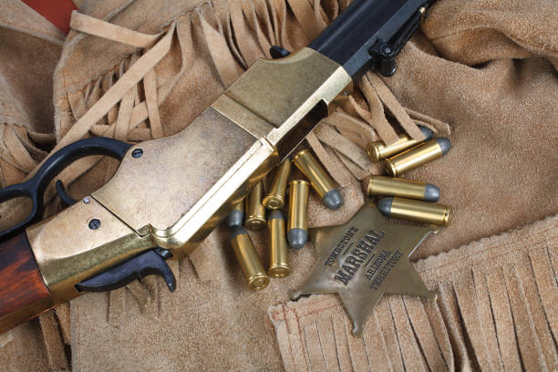 istock Wild west period repeating rifle with ammunition and sheriff badge 917214538