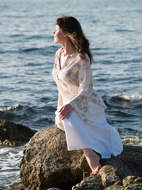 istock Lady Sitting on Sea Rock 91721658