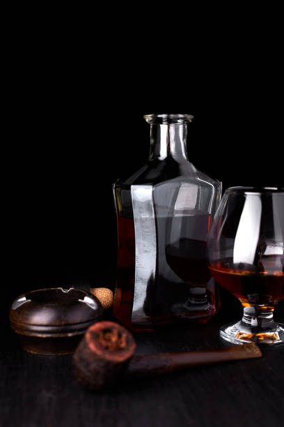 istock Glass of whiskey with smoking cigar. 917217432