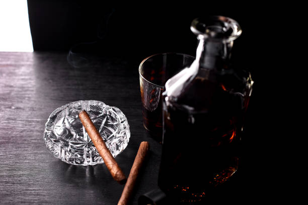 istock Glass of whiskey with smoking cigar. 917217440