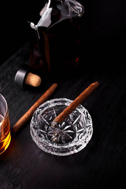 istock Glass of whiskey with smoking cigar. 917217444