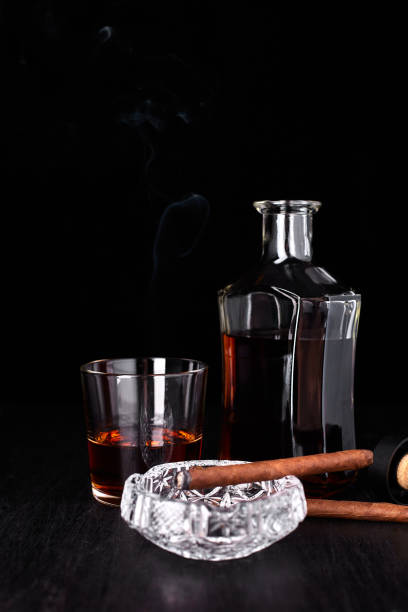istock Glass of whiskey with smoking cigar. 917217448
