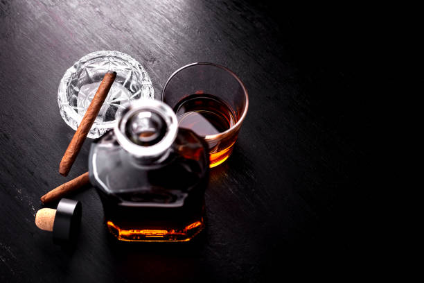 istock Glass of whiskey with smoking cigar. 917217456
