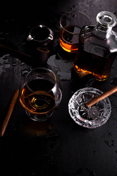 istock Glass of whiskey with smoking cigar. 917217574