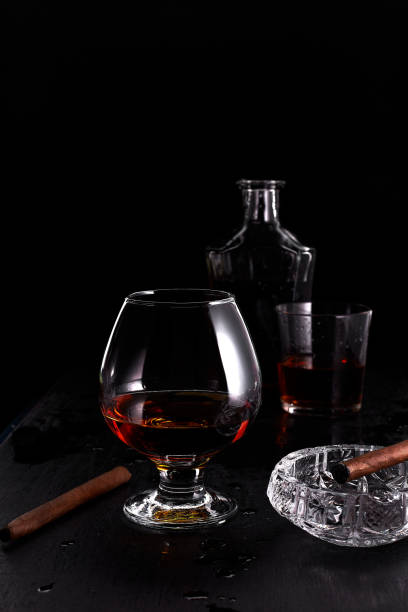 istock Glass of whiskey with smoking cigar. 917217600