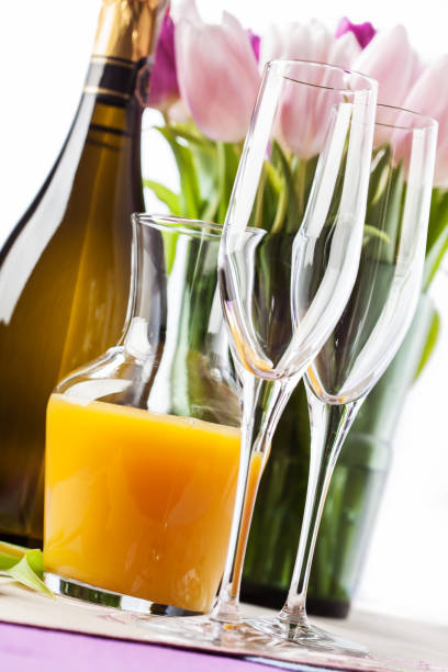 istock Two empty champagne flutes and a bottle of sparkling wine 917218050