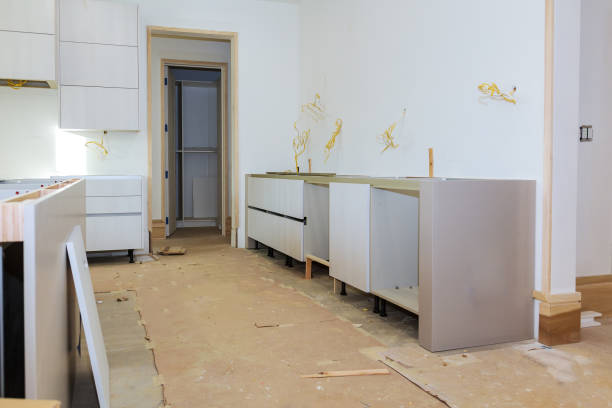 istock Custom kitchen cabinets in various stages of installation base for island in center Installation kitchen cabinets 917224902