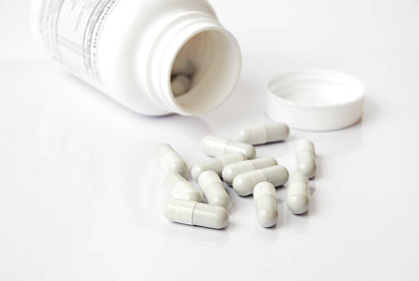 Bottle of white pills stock photo