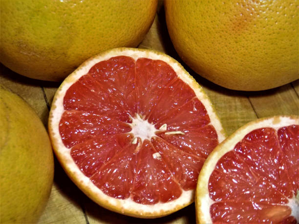 istock Royalty Free Photograph - Sweetest Ruby Red Grapefruit Sliced in Half and ready to Eat 917227600