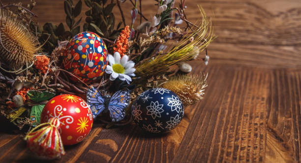 istock Easter background. colored Easter eggs and composition of dried flowers and plants. on wooden background. Easter theme. Happy Easter. 917227792