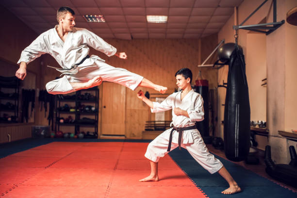 istock Martial arts masters practice kick in jump 917228190