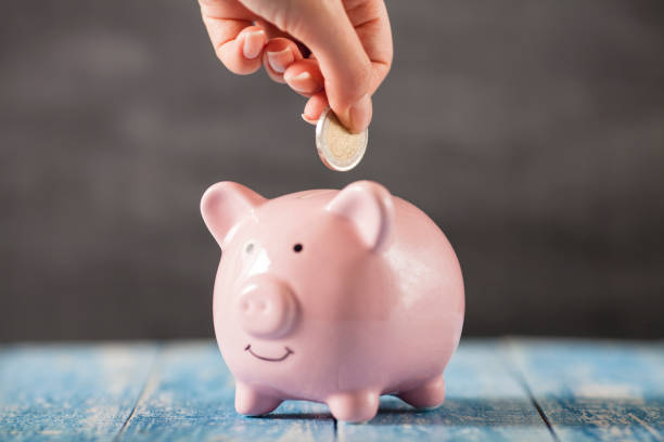 istock Inserting coin on the vintage piggy bank 917229242