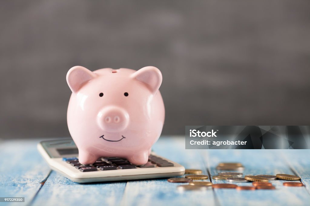 Piggy bank with calculator Savings Stock Photo