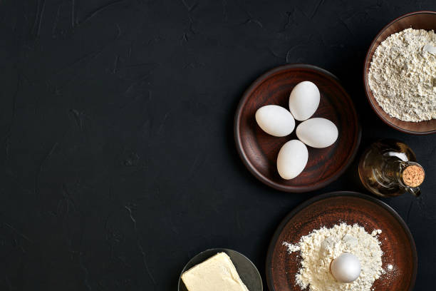 istock Pasta cooking ingredients on black kitchen table. Top view with space for your text 917232566