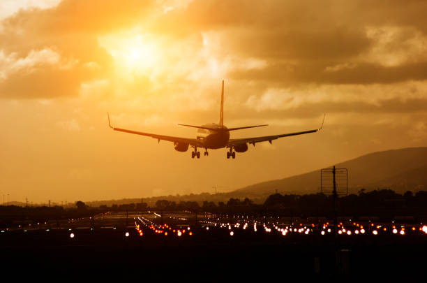 Aeroplane about to land on airport runway stock photo