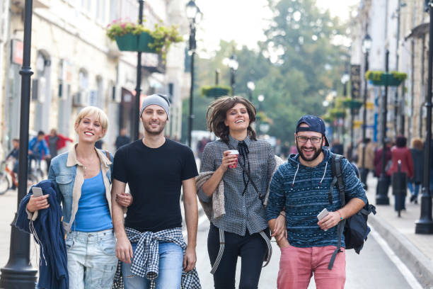 istock Friends walking on street together 917235822