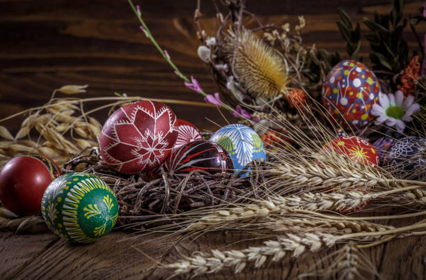 istock Easter background. colored Easter eggs and composition of dried flowers and plants. on wooden background. Easter theme. Happy Easter. 917235946