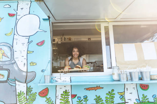istock Female food van worker giving order to customer 917236046