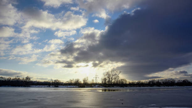 istock colorful winter sunset on frozen river ice 917236082