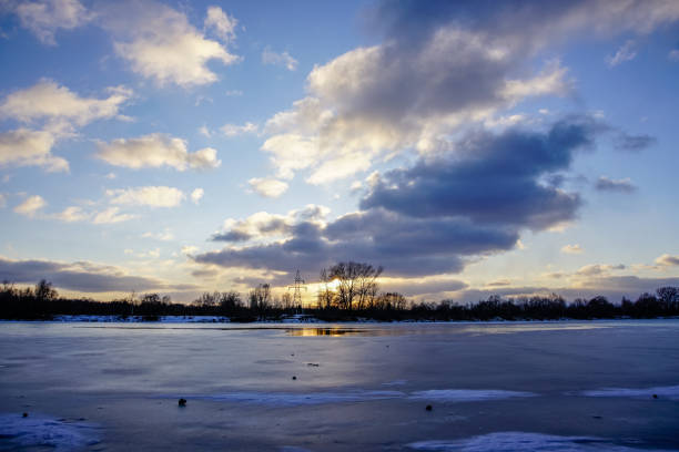 istock colorful winter sunset on frozen river ice 917236110
