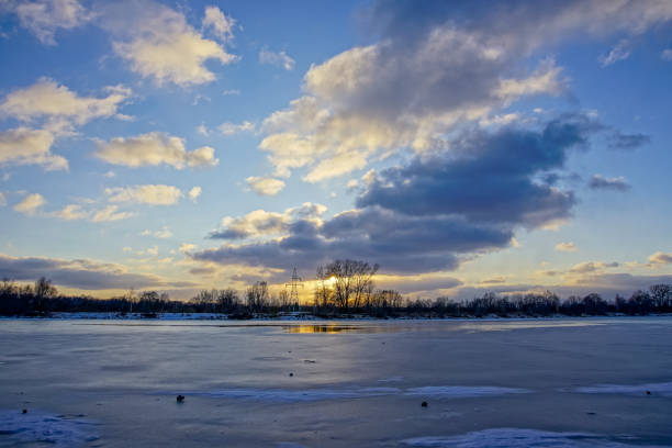 istock colorful winter sunset on frozen river ice 917236138