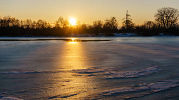 istock colorful winter sunset on frozen river ice 917236178
