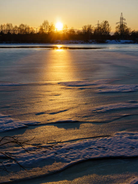 istock colorful winter sunset on frozen river ice 917236192