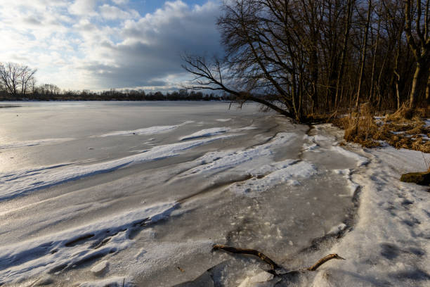 istock colorful winter sunset on frozen river ice 917236222