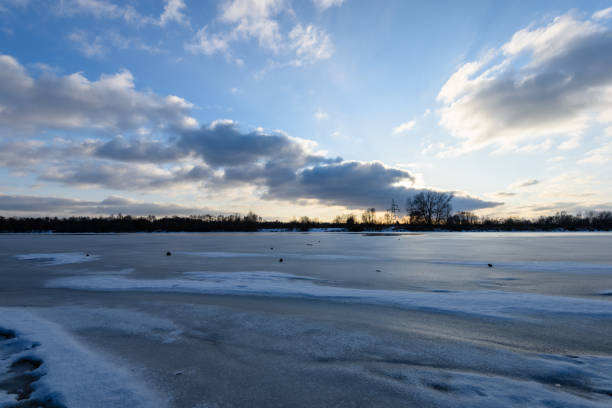 istock colorful winter sunset on frozen river ice 917236292
