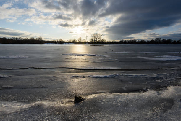 istock colorful winter sunset on frozen river ice 917236324