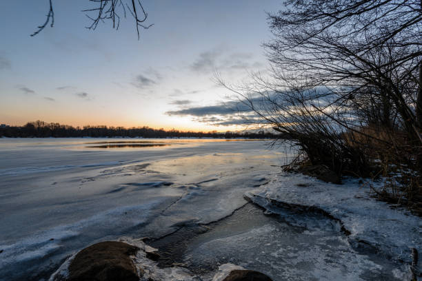 istock colorful winter sunset on frozen river ice 917237518
