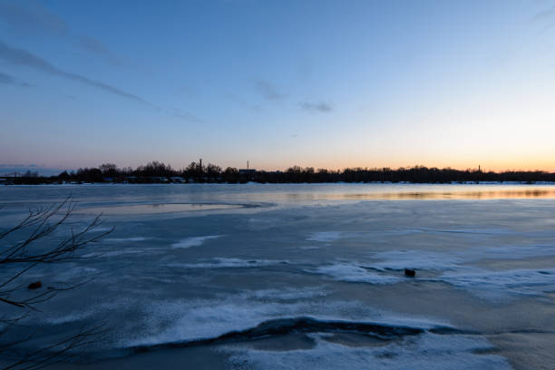 istock colorful winter sunset on frozen river ice 917237530