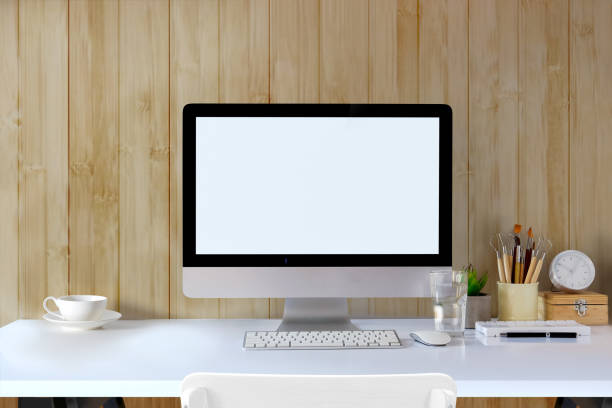 istock Front view workspace mockup desk with desktop computer and office supplies. Blank screen monitor for graphic display montage. 917237572