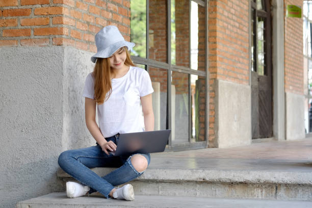 istock Portrait of university student using a laptop on campus. 917238148