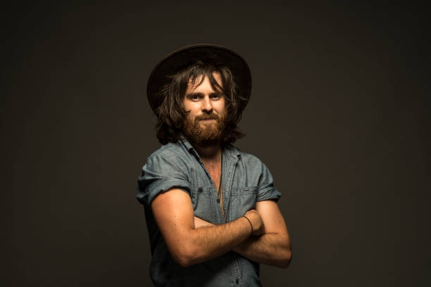 A young man with a beard and scarlet hair. Studio shoot in Australia.